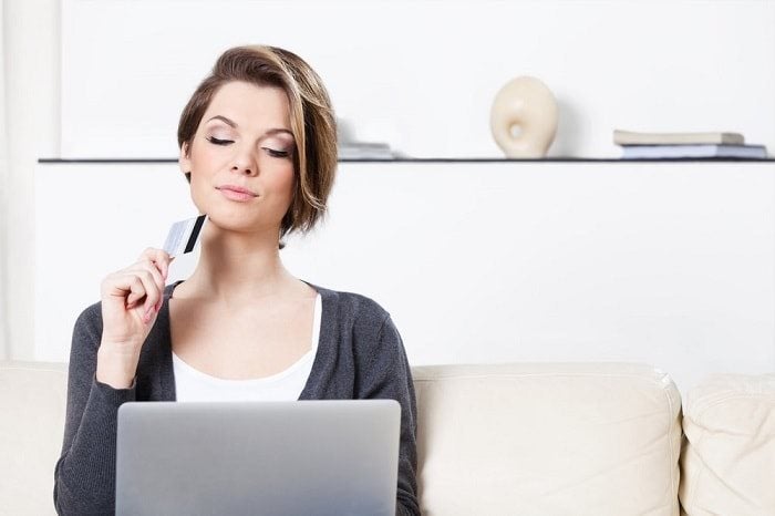 Thinking woman with credit card